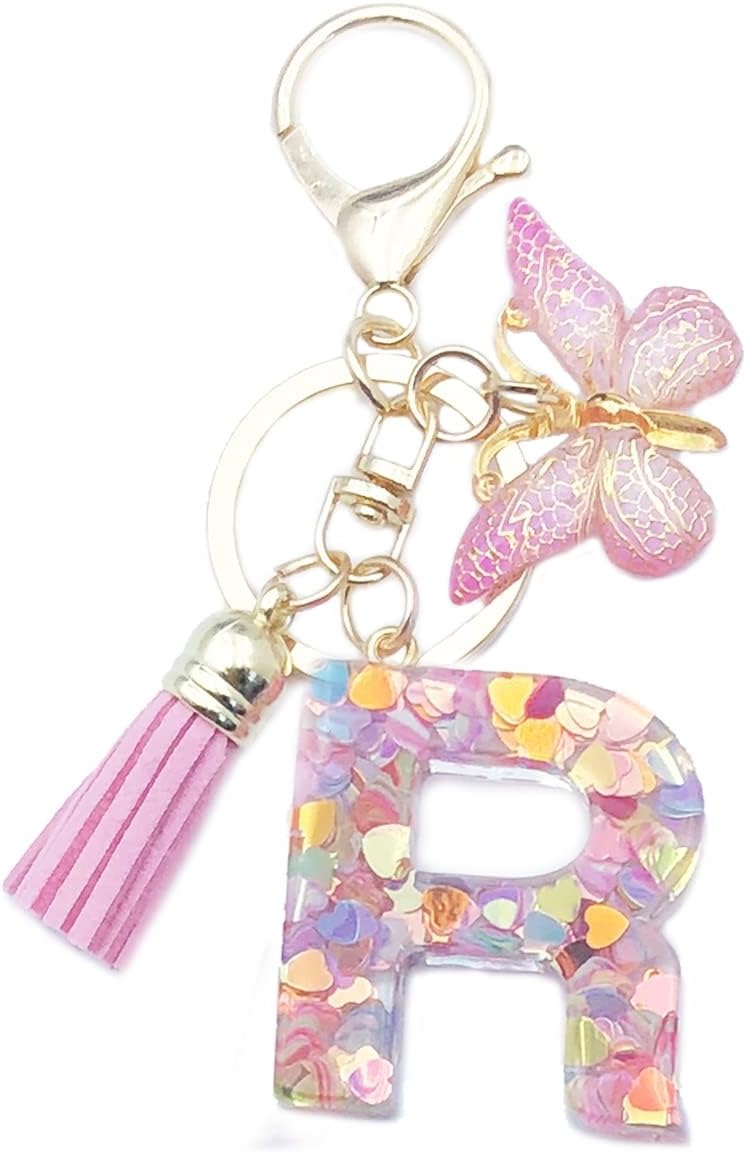 Keychain with letter 'R' charm, pink tassel, and butterfly